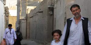 Left:Shir Ahmad in Kabul with his daughter Sadaf,6. His son has left Afghanistan,never to return.