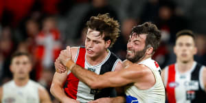 Saints player Mattaes Phillipou is tackled by Luke McDonald of North Melbourne in July 2023.