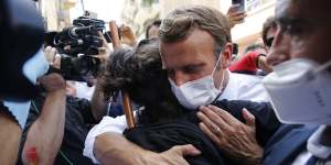French President Emmanuel Macron hugs a resident during a visit to Beirut on Thursday.