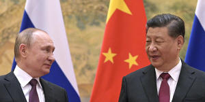 Chinese President Xi Jinping,right,and Russian President Vladimir Putin talk to each other during their meeting in Beijing before the Games. 