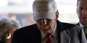 Donald Trump in a “Trump Caucus Captain” hat.