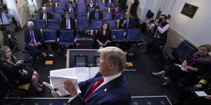 President Donald Trump flips through a stack of papers as he speaks about the coronavirus in the James Brady Press Briefing Room of the White House,Monday,April 20,2020,in Washington. (AP Photo/Alex Brandon)
