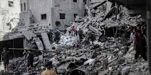 Palestinians inspect the damage following an Israeli airstrike at the Al-Shati refugee camp in Gaza City on Wednesday.