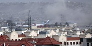 Smoke rises from an explosion outside Kabul airport on Thursday.