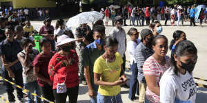 Voters line up to cast their ballots in Dili on Tuesday.