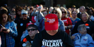 A Trump supporter wears a'Crooked Hillary for prison'T-shirt at a rally at Regent University,Virginia Beach.