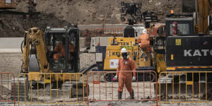 Workers in protective gear at 6 Grand Avenue in Camellia,which is a heavily contaminated site that will become the main stabling yard for trams.