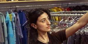 Angela goes through rare and vintage clothing items at SWOP,a consignment store in Newtown.