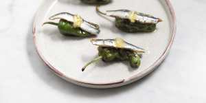 Grill-blistered peppers with anchovy and preserved lemon.