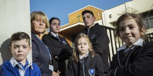 Alphington Grammar School principal Dr Vivianne Nikou stands with students Miles,Isabella,Zoe,Ethan and Nikoletta at the school gates.