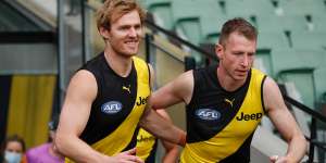 Richmond retiree and triple-premiership player David Astbury runs on to the field for his final game alongside great mate Dylan Grimes.