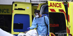 A patient is taken from an ambulance outside St Thomas'Hospital in London.
