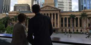 Outgoing Brisbane lord mayor Graham Quirk and his wife Anne look back at City Hall on the morning he announced he was stepping down from council.