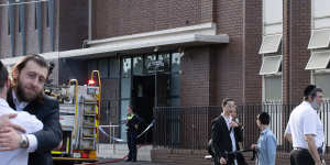 Congregants comfort each other outside the synagogue on Friday morning.