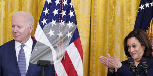 US Vice President Kamala Harris applauds as President Joe Biden looks on.