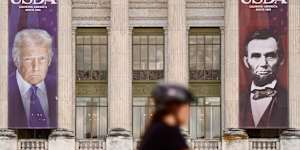 Banners showing the faces of US Presidents Donald Trump and Abraham Lincoln on the US Department of Agriculture building in Washington.