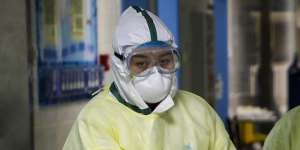 A patient with COVID-19 is treated in a hospital’s isolation ward in Wuhan,China in February 2020. 