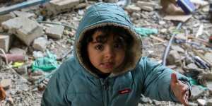 A child is pictured among the rubble of a house in Rafah,Gaza.