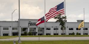 A flag flies at half-mast at Daniel Defense’s headquarters in Black Creek,Georgia,on May 27,after one of its guns was used in the Uvalde school massacre.