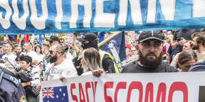 Protesters carrying signs at the front of the rally in Sydney