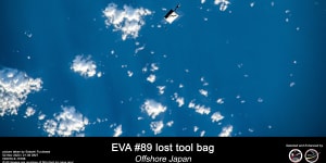 This photograph taken by a Japanese astronaut aboard the ISS shows the lost tool bag over Earth.