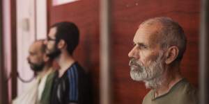John Harding seen behind bars in a courtroom in Donetsk in August.