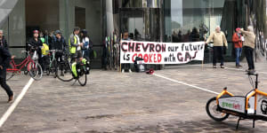 Grandparents superglue themselves to Chevron HQ in Perth protest