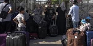 Palestinians wait to cross into Egypt at Rafah,Gaza Strip.