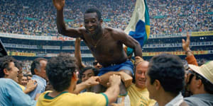 Pelé is hoisted on the shoulders of his teammates after Brazil won the 1970 World Cup.