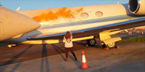 Screengrabs from a video posted by activist group Just Stop Oil of private jets being spray-painted at a London airport. 