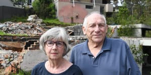 Susan Magnay and Philip Bull in front of the ruins of their home in Malua Bay.