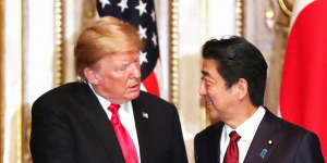 Then-president Donald Trump shakes hands with Shinzo Abe in Japan in 2019. 