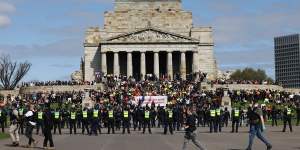 Police surround protesters at the Shrine of Remembrance.