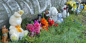 Toys,flowers and candles have been left in tribute near the home in Coonabarabran.