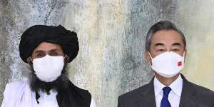 In July,Taliban co-founder Mullah Abdul Ghani Baradar,left,and Chinese Foreign Minister Wang Yi pose for a photo during their meeting in Tianjin,China. 