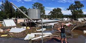 Brad McCutcheon,a resident of St George Caravan Park,surveys the scene during flooding of the Hawkesbury River near Sydney in March 2021.