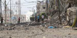 Palestinian citizens inspect damage to their homes caused by Israeli airstrikes in Gaza.