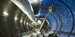 Workers install lining to tunnels in the Hunter Street station.