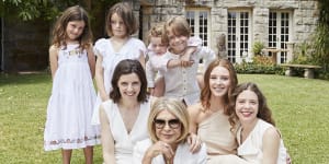 Carla Zampatti with her daughters,Bianca (right) and Allegra Spender,and five of her nine grandchildren.