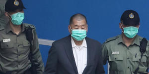 Jimmy Lai,centre,pictured in custody earlier this month.