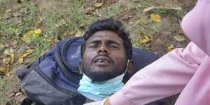 An ethnic Rohingya man receives medical treatment from a health worker after he and his group landed in Indonesia.