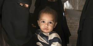 Australian mother Zahra Ahmed (left) holding her son Ibrahim (2nd from left) in al-Hawl camp in north-east Syria,October 2019.