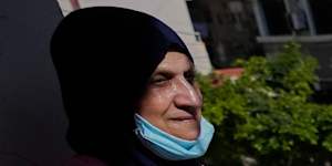 A woman looks through her damaged apartment that was hit a few weeks ago by an Israeli air strike in the southern city of Tyre.