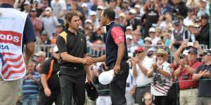 Aaron Baddeley shaking hands with Tiger Woods after the US won the Presidents Cup in 2011.