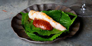 Skull Island prawn “taco” served on aromatic leaves with chilli sambal.