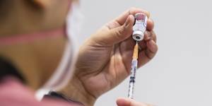 A Melbourne health worker prepares a dose of the Pfizer vaccine. 