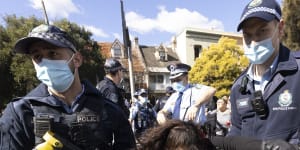 Police arrest a woman on Broadway during the Sydney rally on Saturday. 
