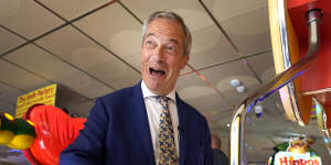 Nigel Farage plays on a game in an amusement arcade while spending time with supporters in Clacton-on-Sea.