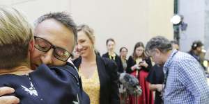 Di Natale embraces his children Luca and Ben and his wife Lucy after announcing his resignation.