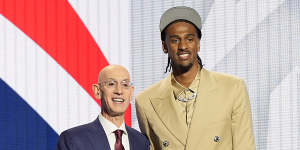 NBL Next Star Alex Sarr,right,poses with NBA commissioner Adam Silver after being drafted by the Washington Wizards.